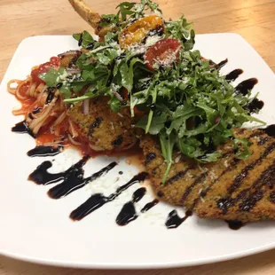 Romano Breaded Veal Chop over Linguini, Arugula Salad, Balsamic Reduction.