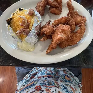 Coconut shrimp with baked potato.