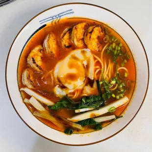 Fresh made noodle with shrimp and sous vide egg in tomato broth