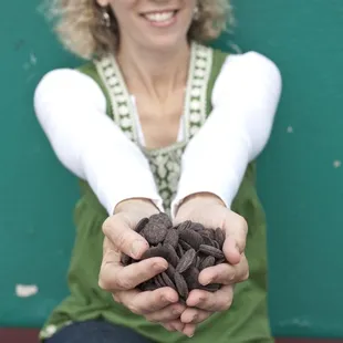 Hands full of chocolate waiting to be made into truffles.