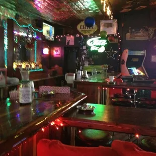 a bar with red chairs