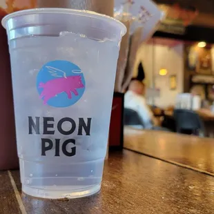 a plastic cup on a wooden table