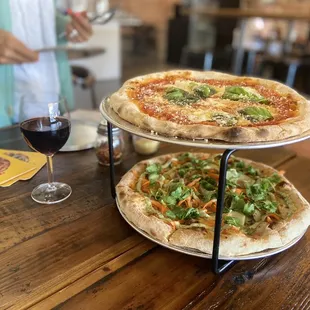 two pizzas and a glass of wine