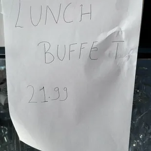 Sign taped up for the price of the Lunch Buffet