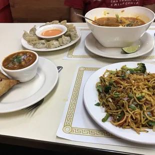 a plate of noodles and a bowl of soup