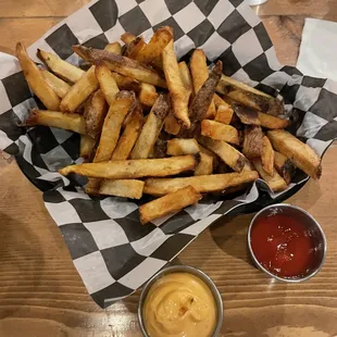 Basket of fries with aioli and spicy ketchup