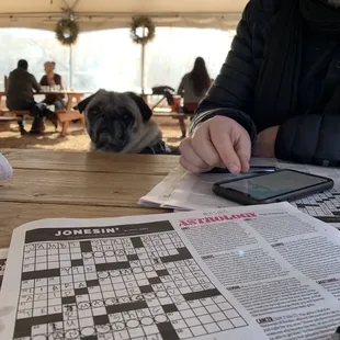 a man sitting at a table with a cell phone