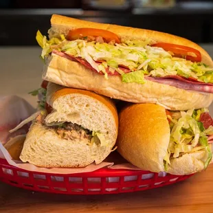 a pile of sub sandwiches