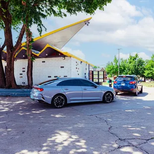 a silver car parked in front of a gas station