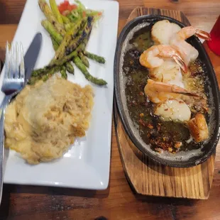 Broiled shrimp and scallop combo with mash potatoes and asparagus.