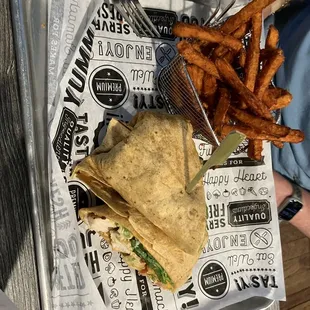 Chicken chipotle wrap with sweet potato fries.
