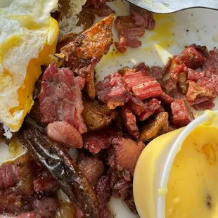 Greasy gross corn beef hash with burnt eggs