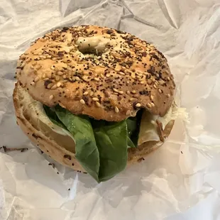 Spinach, egg, and onion on an everything bagel