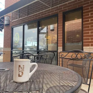 My Cortado coffee sitting on the patio at nervous dog.