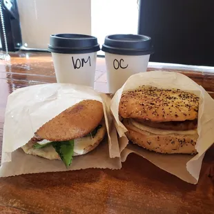a bagel sandwich and a coffee cup
