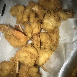 a close up of fried shrimp and fries