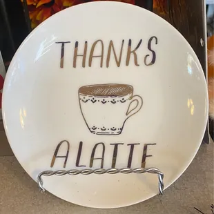 a plate with a cup of coffee on it