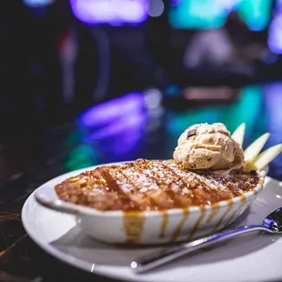 a bowl of food with ice cream and caramel
