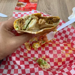 Burrito de Carne Mechada. Filled with shredded beef, queso de mano, lettuce, tomatoes, and house sauce