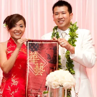 Kana (in her third gown for the evening) &amp; Kin display the beautiful scroll presented to them by the lions.  Photo by Visionari.