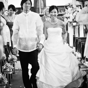 The happy couple strolls down the aisle after having been pronounced &quot;husband and wife.&quot;  Photo by Kris Labang Photography.