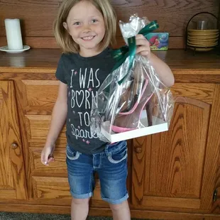 a young girl holding a bag of candy