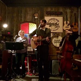 a man playing guitar and a woman singing