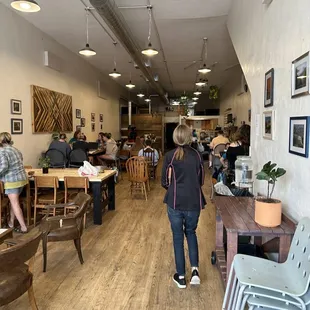 people sitting at tables in a cafe