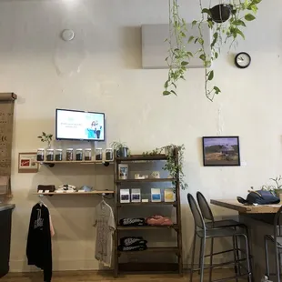 a living area with a table, chairs, and a television