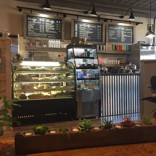 a bakery counter with a variety of food items