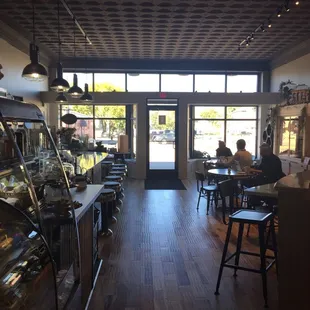 people sitting at tables in a cafe
