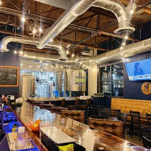 a long bar with a television on the wall