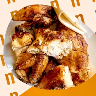 a plate of chicken with a side of bread