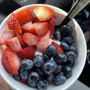 Yellow cake batter, with strawberries and blueberries.