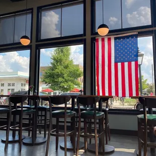 a view of the american flag from inside a restaurant