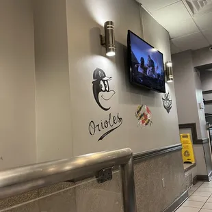 a tv mounted on the wall of a restaurant