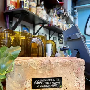 a brick with a sign on it