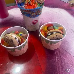 Two scoops of ice cream topped with cookies and candy.