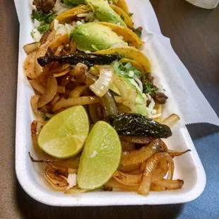 Carne asada tacos with avacado and cheese i asked to add to the plate