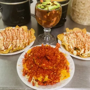 three plates of food and a glass of wine