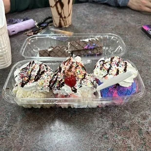 Banana split, chocolate milkshake in the back