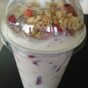 a yogurt with strawberries and granola