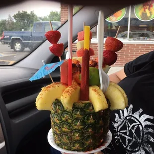 a pineapple with strawberries, strawberries, and pineapples