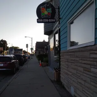 a sidewalk with cars parked on it