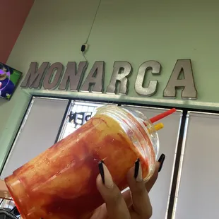 a woman holding a drink