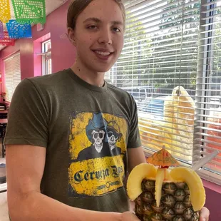 My boyfriend holding our wonderful piña colada