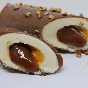 a close up of a chocolate covered ice cream roll