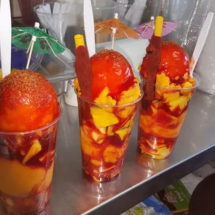 a close up of three cups of fruit