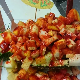 a pineapple filled with chopped vegetables