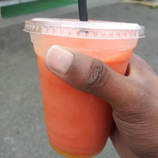 a hand holding a drink